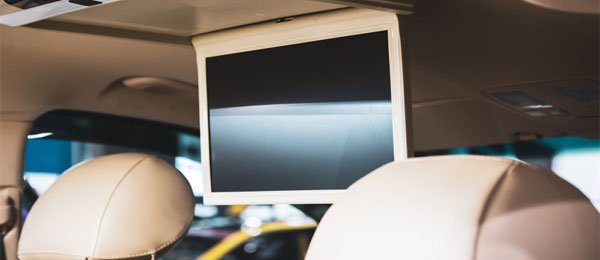 Large video monitor mounted to the ceiling of a vehicle